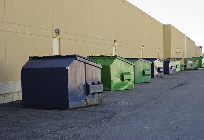 a series of colorful, utilitarian dumpsters deployed in a construction site in Bucyrus